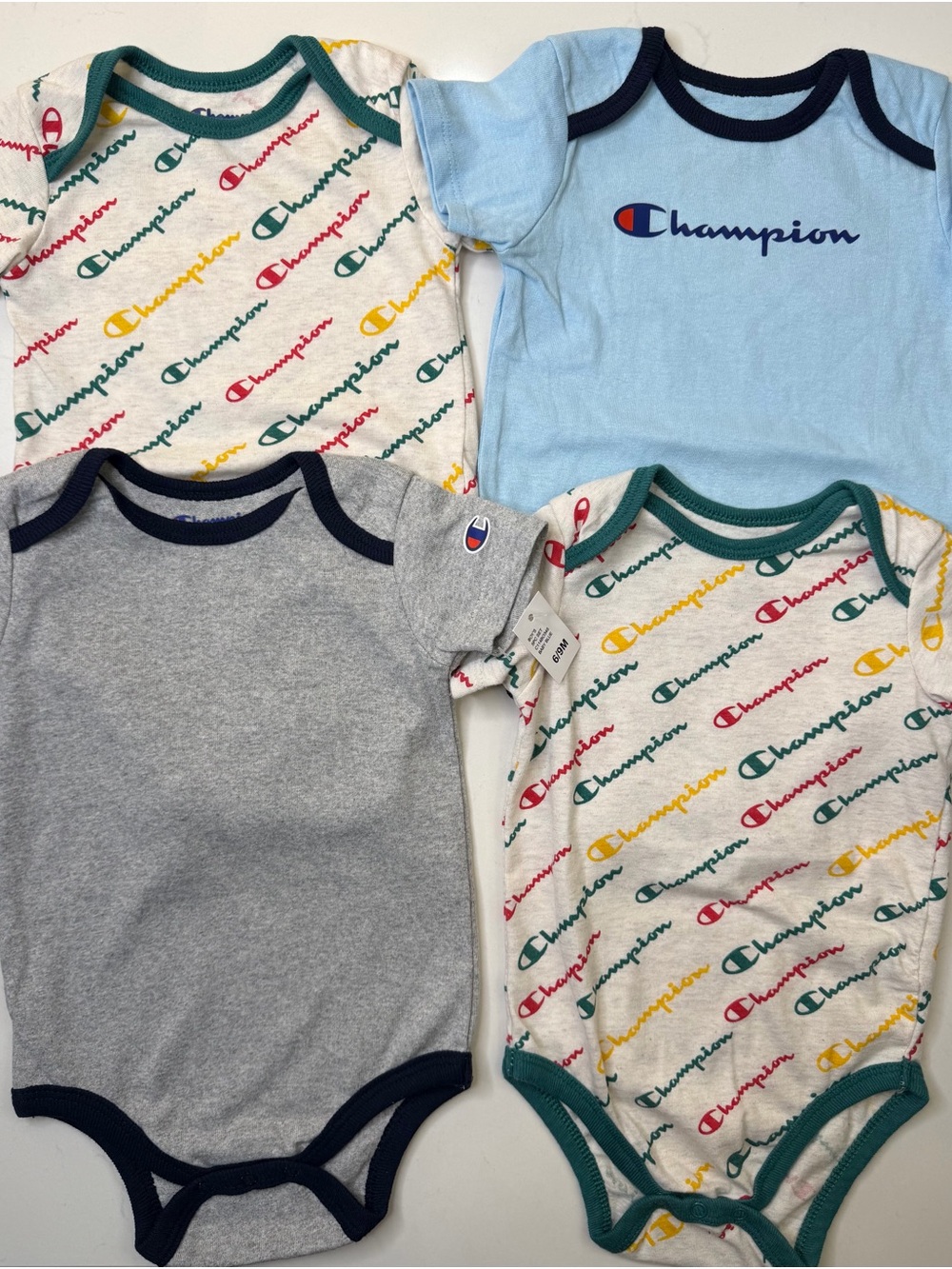 Champion 4-piece baby bodysuit bundle in size 6-9 months/9 months